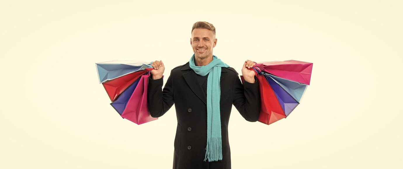 cheerful shopping man with purchase Kilts product